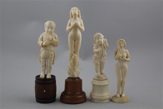 A late 19th century German carved ivory figure standing on a barrel, largest 6.5in. incl. wood plinth